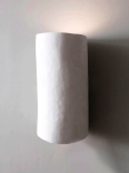 Curved and sculpted in plaster, the Serenity wall light by Hannah Woodhouse is the perfect wall sconce for spas, hotels and residential interiors.